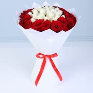 Fresh flower bouquet with red and white roses arranged in a balanced round shape, creating a visually pleasing romantic design