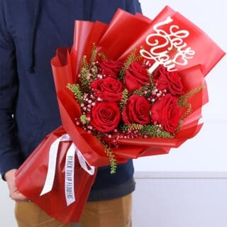 Valentine mini bouquet with fresh red roses and fillers, hand-tied in an elegant wrapping for romantic gifting.