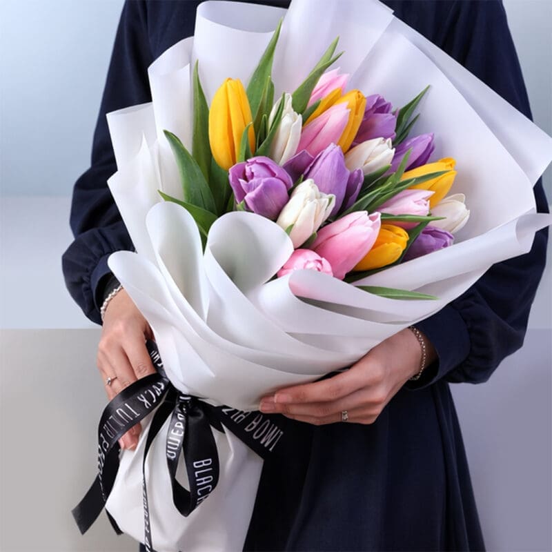 mixed-tulip-bouquet-20-stems Bouquet featuring 20 mixed tulips in white wrapping style, finished with a black ribbon and a premium presentation.