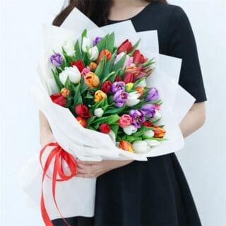 Flower Not Found 25 Mixed tulip bouquet with vibrant colours wrapped in white decorative paper and tied with a red satin ribbon.