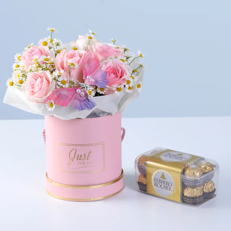 flutter-flower-and-chocolate-gift-box Paired with Ferrero chocolates, the arrangement highlights decorative butterfly and pink roses accented for an elegant and visually striking presentation.