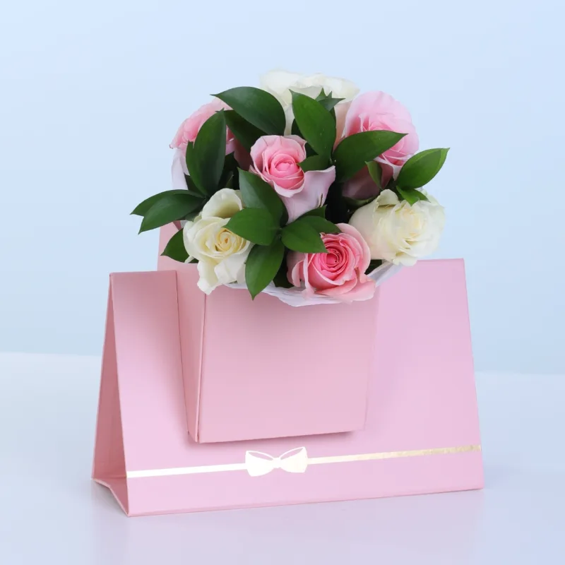 blush-rose-floral-envelope-box Blush Rose Floral Envelope Box featuring 3 fresh pink roses, 3 white roses, and 5 stems of lush ruscus arranged in a premium floral envelope box for gifting and special occasions.