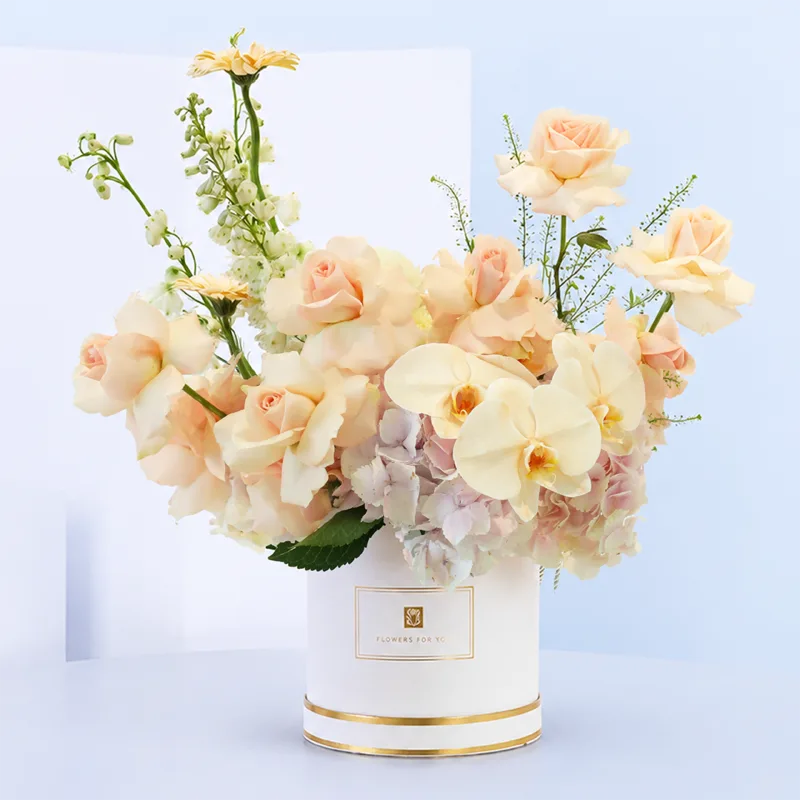 peach-blossom-hat-box Peach Blossom Hat Box featuring peach roses, white matthiola, peach gerberas, and light pink hydrangeas beautifully arranged in a premium white flower hat box.