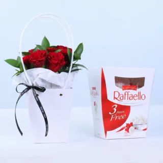 Red Rose Floral Bag with Ferrero Raffaello featuring 7 fresh red roses, 5 stems of lush ruscus, and Ferrero Raffaello chocolates arranged in a premium white floral bag for gifting and special occasions.